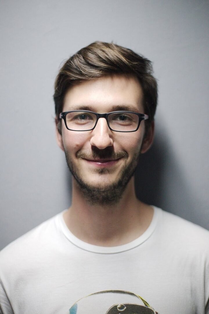 Portrait of a man facing slightly to his left, before flipping